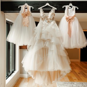 A,Dreamy,Wedding,Gown,And,Two,Girl,Dresses,Hang,Side